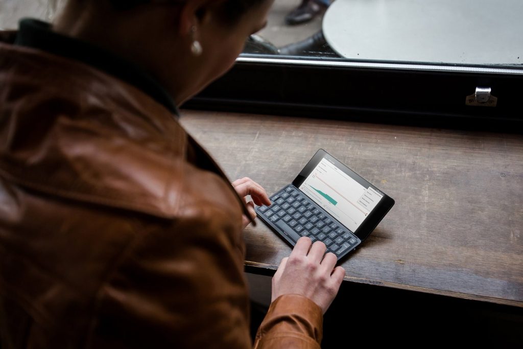 A woman typing on a Gemini PDA device